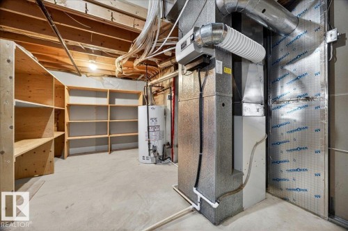 Unfinished basement with concrete flooring and exposed ceiling joists - 11824 13 Avenue, Edmonton, AB - Indoor Photo Showing Basement