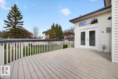 Expansive outdoor deck featuring painted wood planks and a white spindle railing - 11824 13 Avenue, Edmonton, AB - Outdoor With Deck Patio Veranda With Exterior