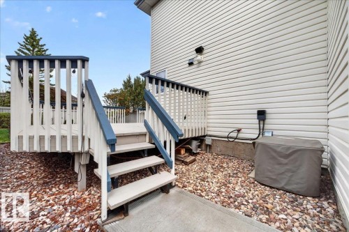 Raised exterior deck with white and blue railing, accessible via stairs - 11824 13 Avenue, Edmonton, AB - Outdoor With Exterior