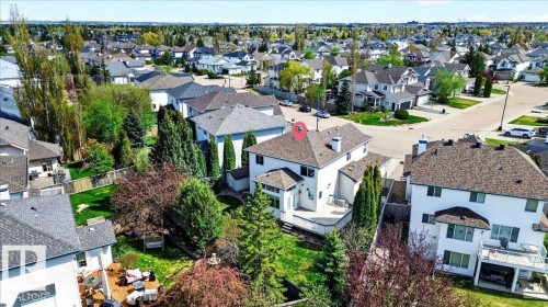 Aerial perspective showcasing a residential property with a multi-level deck, mature landscaping, and a fenced backyard - 11824 13 Avenue, Edmonton, AB - Outdoor