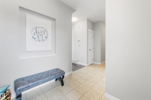Entryway featuring light-colored tile flooring and a decorative wall niche - 607 40 Street Sw, Edmonton, AB - Indoor Photo Showing Other Room