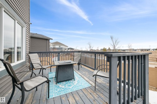 The property features an exterior deck with a wooden railing and grey siding - 607 40 Street Sw, Edmonton, AB - Outdoor With Deck Patio Veranda With Exterior