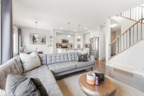 Living room with dark wood flooring and a light-colored rug - 607 40 Street Sw, Edmonton, AB - Indoor Photo Showing Living Room