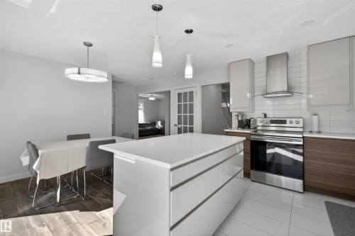 Open-concept kitchen with a large central island, stainless steel appliances, and contrasting cabinetry - 15251 88A Street, Edmonton, AB - Indoor Photo Showing Kitchen With Upgraded Kitchen