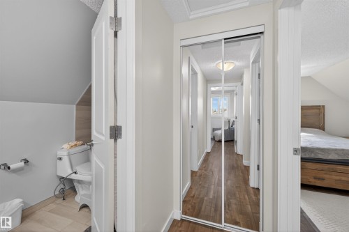 Hallway featuring wood-finish flooring, mirrored closet doors, and recessed lighting - 15251 88A Street, Edmonton, AB - Indoor Photo Showing Other Room
