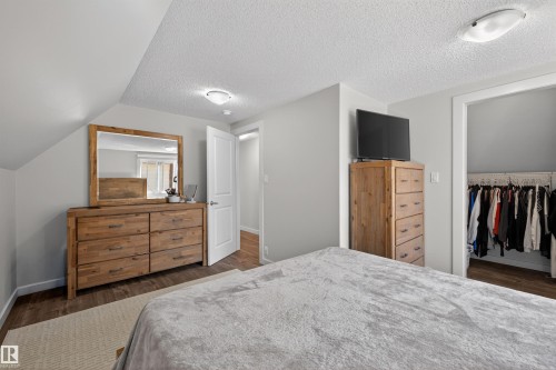Bedroom featuring sloped ceilings, light gray wall paint, and wood-finish flooring - 15251 88A Street, Edmonton, AB - Indoor Photo Showing Bedroom