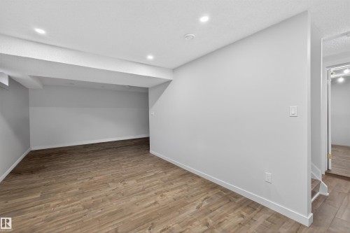 Finished lower level featuring wood-finish flooring and recessed lighting - 15251 88A Street, Edmonton, AB - Indoor Photo Showing Other Room