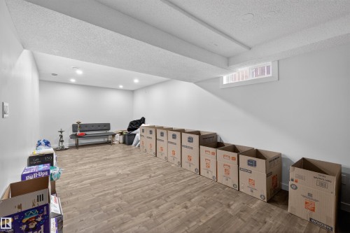Spacious room with wood-finish flooring, recessed lighting, and light-toned walls - 15251 88A Street, Edmonton, AB - Indoor