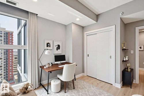 Light wood-finish flooring complements the neutral wall tones - #1601 10180 103 St Nw, Edmonton, AB - Indoor