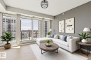 Expansive floor-to-ceiling windows with roller blinds, light wood-finish flooring, recessed ceiling lighting, a modern ceiling pendant light, and a neutral wall color - #1601 10180 103 St Nw, Edmonton, AB  - Indoor Photo Showing Living Room 