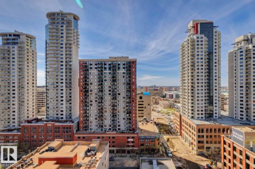 Modern high-rise residential building with a glass-enclosed top floor and multiple balconies - #1601 10180 103 St Nw, Edmonton, AB - Outdoor With Facade
