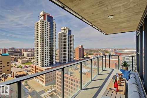 Private balcony featuring clear glass railing, concrete flooring, and an overhead lighting fixture - #1601 10180 103 St Nw, Edmonton, AB - Outdoor With Balcony With View