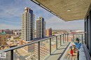 Private balcony featuring clear glass railing, concrete flooring, and an overhead lighting fixture - #1601 10180 103 St Nw, Edmonton, AB  - Outdoor With Balcony With View 