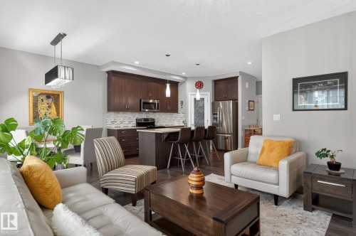 Open-concept living area featuring wood-finish flooring - 83 Sandalwood Place, Leduc, AB - Indoor Photo Showing Living Room