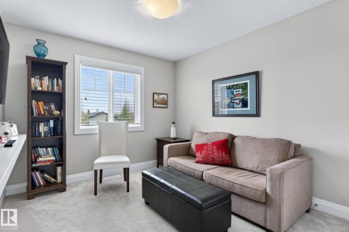Neutral color palette featuring light-toned walls and carpet flooring - 83 Sandalwood Place, Leduc, AB - Indoor Photo Showing Living Room