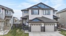 Contemporary two-story residence featuring light-toned siding and blue accent gables - 83 Sandalwood Place, Leduc, AB  - Outdoor With Facade 