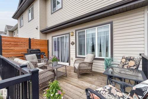 Expansive wooden deck featuring black metal railings and a privacy fence - 83 Sandalwood Place, Leduc, AB - Outdoor With Deck Patio Veranda With Exterior