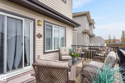 Expansive wood deck with a black metal railing - 83 Sandalwood Place, Leduc, AB - Outdoor With Deck Patio Veranda With Exterior