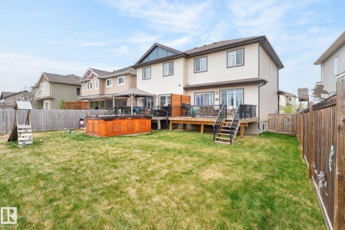 Expansive backyard featuring a hot tub, a multi-level wooden deck with black railings, and a gazebo - 83 Sandalwood Place, Leduc, AB - Outdoor With Deck Patio Veranda