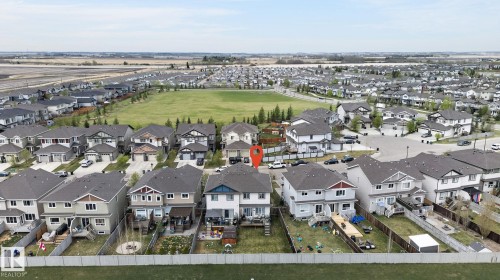 Aerial view showcasing a residential development with a large green space - 83 Sandalwood Place, Leduc, AB - Outdoor With View