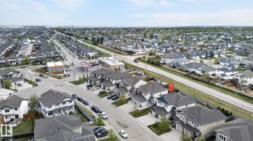 Aerial perspective showcasing a residential neighborhood with diverse housing styles - 83 Sandalwood Place, Leduc, AB - Outdoor With View