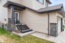 Cream-toned siding exterior with dark trim accents - 83 Sandalwood Place, Leduc, AB  - Outdoor 