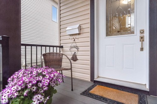Front entry featuring a white paneled door with decorative glass insert and brass hardware - 83 Sandalwood Place, Leduc, AB - Outdoor With Exterior