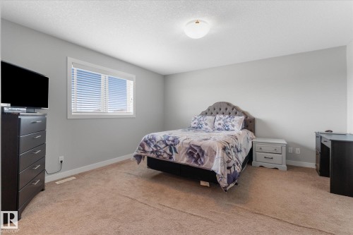 Bedroom featuring light gray wall paint, a window with horizontal blinds, and neutral carpet flooring - 3 Richmond Link, Fort Saskatchewan, AB - Indoor Photo Showing Bedroom