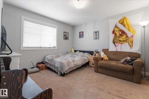 Carpeted room featuring a single window with blinds, light gray wall paint, and a ceiling-mounted light fixture - 3 Richmond Link, Fort Saskatchewan, AB - Indoor Photo Showing Bedroom