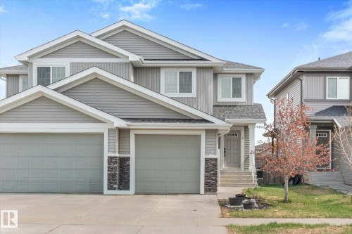 Modern duplex with light gray siding and white trim - 3 Richmond Link, Fort Saskatchewan, AB - Outdoor With Facade