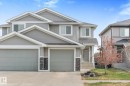 Modern duplex with light gray siding and white trim - 3 Richmond Link, Fort Saskatchewan, AB  - Outdoor With Facade 