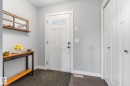 Entryway featuring a white paneled door with transom windows and dark hardware, accompanied by two paneled closet doors - 3 Richmond Link, Fort Saskatchewan, AB  - Indoor Photo Showing Other Room 