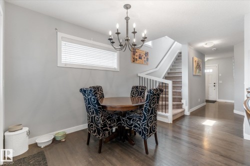 Dining area featuring wood-finish flooring and a central chandelier - 3 Richmond Link, Fort Saskatchewan, AB - Indoor Photo Showing Dining Room