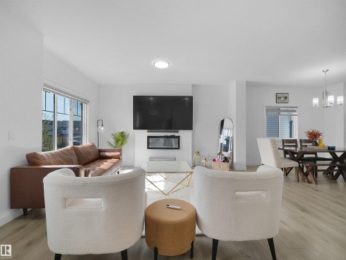Open-concept living space featuring light wood-finish flooring and white walls - 30 Hope Cm, Spruce Grove, AB - Indoor