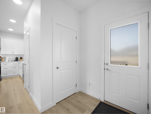 Entryway featuring a white door with an upper glass pane, recessed lighting, and wood-finish flooring - 30 Hope Cm, Spruce Grove, AB - Indoor Photo Showing Other Room