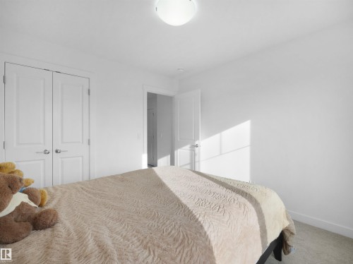 Bedroom featuring white walls, light-colored carpet flooring, and a flush mount ceiling light - 30 Hope Cm, Spruce Grove, AB - Indoor Photo Showing Bedroom