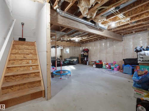 Unfinished basement featuring exposed wood joists and concrete flooring - 30 Hope Cm, Spruce Grove, AB - Indoor Photo Showing Basement
