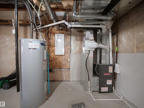 Utility area featuring a water heater, furnace, and exposed ductwork - 30 Hope Cm, Spruce Grove, AB - Indoor Photo Showing Basement