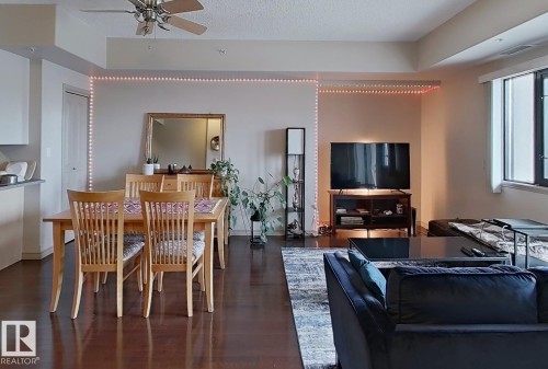 Open-concept living space featuring wood-finish flooring, a contemporary ceiling fan, and recessed lighting - 707 10319 111 Street Nw, Edmonton, AB - Indoor Photo Showing Dining Room