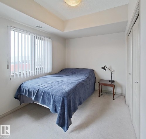 Tray ceiling with recessed lighting - 707 10319 111 Street Nw, Edmonton, AB - Indoor Photo Showing Bedroom