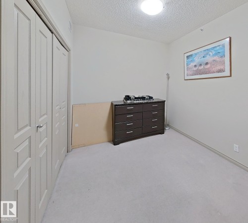Light-colored carpeting complements neutral wall tones - 707 10319 111 Street Nw, Edmonton, AB - Indoor