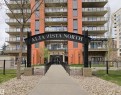 Multi-story residential building featuring a stone and stucco facade - 707 10319 111 Street Nw, Edmonton, AB  - Outdoor With Balcony With Facade 