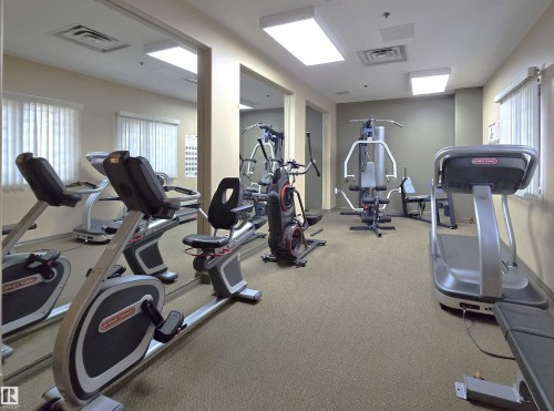 Dedicated fitness space featuring full-wall mirrors and recessed lighting - 707 10319 111 Street Nw, Edmonton, AB - Indoor Photo Showing Gym Room