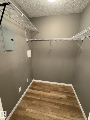 Storage area featuring wood-finish flooring and ample wire shelving - 138 9525 162 Avenue, Edmonton, AB 