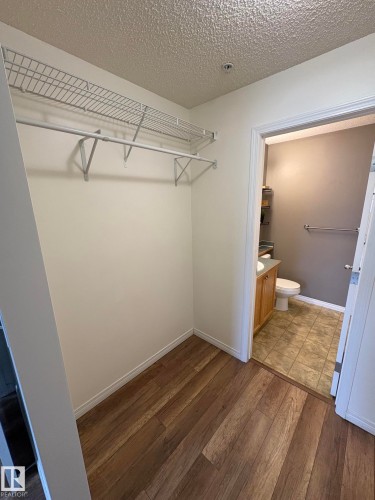 Walk-in closet with wire shelving and hanging rod - 138 9525 162 Avenue, Edmonton, AB 