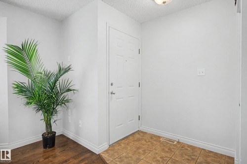 Entryway featuring a paneled door with brushed nickel hardware - 16211 55A Street, Edmonton, AB - Indoor Photo Showing Other Room
