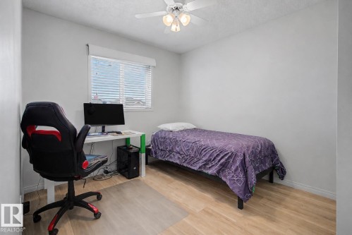 Room featuring wood-finish flooring, white walls, and a window with blinds - 16211 55A Street, Edmonton, AB - Indoor Photo Showing Bedroom