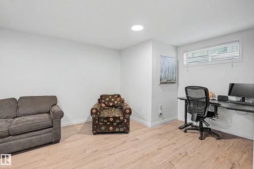 Spacious room featuring light wood-finish flooring, recessed lighting, and a horizontal window with blinds - 16211 55A Street, Edmonton, AB - Indoor Photo Showing Other Room