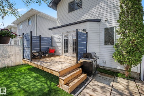 Ground-level wooden deck with privacy screening - 16211 55A Street, Edmonton, AB - Outdoor With Deck Patio Veranda With Exterior