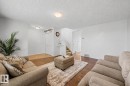 Spacious living area featuring rich wood-finish flooring - 16211 55A Street, Edmonton, AB  - Indoor Photo Showing Living Room 